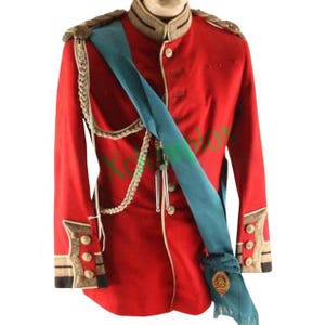 May include: A red military uniform jacket with gold buttons and a blue sash. The jacket has a high collar and a stand-up collar. The sash is tied around the waist and has a gold tassel.