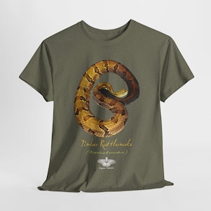 Op de afbeelding: Een groen T-shirt met een afbeelding van een Timber Rattlesnake (Crotalus horridus) in een opgerolde positie. De tekst "Timber Rattlesnake (Crotalus horridus)" is onder de slangafbeelding gedrukt. De tekst "Faun & Flora" is onder de naam van de slang gedrukt.