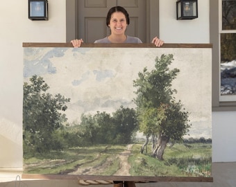 May include: A large rectangular landscape print featuring a dirt path winding through green trees and fields under a pale sky, held within a dark wooden frame with horizontal bars at the top and bottom edges of the artwork.