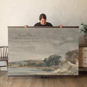 May include: A large framed print featuring a watercolor landscape with a bridge, water, and trees in muted tones. The print includes the text "The Lord God is my strength and my song, and he has become my salvation Isaiah 12:2."