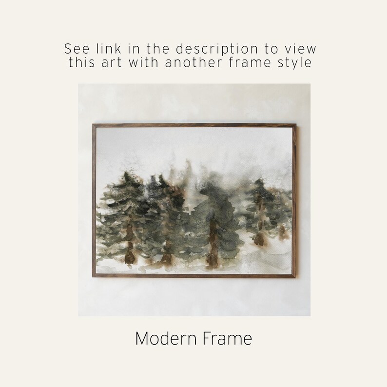 May include: Watercolor painting of a forest scene in muted greens and browns, framed in a dark wood. The artwork features a misty, atmospheric depiction of trees. Text at the bottom reads "Modern Frame". Above the artwork, text reads "See link in the description to view this art with another frame style".