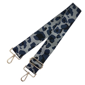 May include: A gray and navy blue patterned bag strap with gold-colored metal hardware. The strap features a leopard print design and includes two swivel hooks and a metal buckle for adjustment.