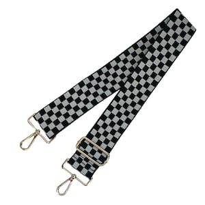May include: Black and white checkered adjustable strap with gold metal hardware. The strap is approximately 1.5 inches wide.