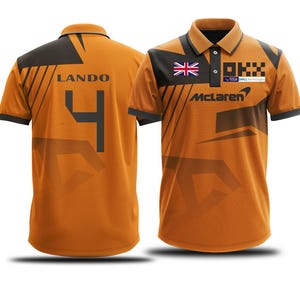 May include: Orange and black polo shirt with the number 4 and the word "LANDO" on the back. The front of the shirt has the McLaren logo and the Union Jack.