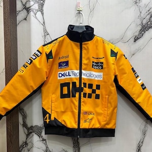 May include: A bright yellow racing jacket with black accents, a black collar, and a full-length zipper. The jacket features multiple sponsor logos, the text "DELL Technologies", and the number "4".