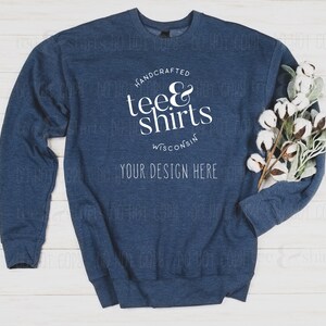 May include: A navy blue sweatshirt with the text "HANDCRAFTED tee & shirts WISCONSIN YOUR DESIGN HERE" printed on the front.