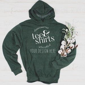 May include: A dark green hooded sweatshirt with the text "HANDCRAFTED tee&shirts WISCONSIN YOUR DESIGN HERE" printed on the front.