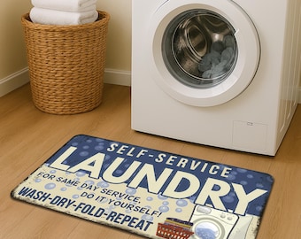 May include: A rectangular floor mat with a blue background featuring white bubbles and the text SELF-SERVICE LAUNDRY, FOR SAME DAY SERVICE, DO IT YOURSELF, and WASH-DRY-FOLD-REPEAT, along with a graphic of a red laundry basket and a washing machine.