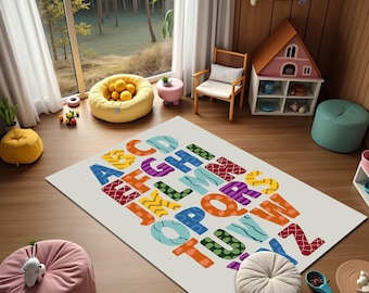 May include: A rectangular children's rug with a colorful alphabet design. The letters are in various colors and patterns, including blue, orange, purple, and green. The rug is on a wooden floor in a playroom setting.