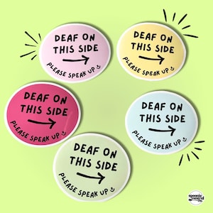 May include: Five circular stickers in pastel shades, each bearing the text "DEAF ON THIS SIDE" and "PLEASE SPEAK UP" in black. A black arrow indicates direction. The background is a pale green.