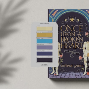 May include: A book cover with a dark purple background and gold lettering that reads "Once Upon A Broken Heart". The cover features a knight in armor and a woman with a crown. The book is by Stephanie Garber. A color chart with the title "Mark My Words" is shown on the left side of the image.