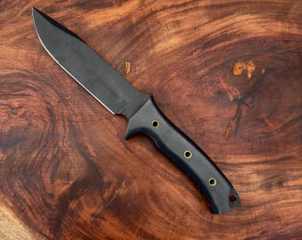 Cuchillo de supervivencia SCK-05, fabricado artesanalmente en acero 440C con mango de Micarta. Cuchillo Bowie tradicional con funda de cuero.