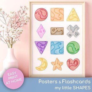 May include: A framed print displaying a collection of watercolour shapes in various colours. The print includes the text "Posters & Flashcards" and "my little SHAPES". A pink circle with the text "EASY PRINT AT HOME" is in the lower left corner.
