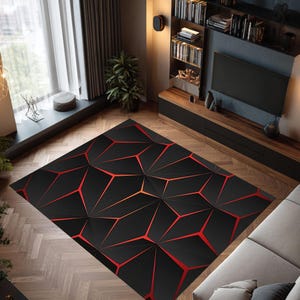 May include: A geometric area rug with a 3D design. The rug features a black background with red angular lines creating a modern, abstract pattern. The rug is rectangular and placed on a hardwood floor.
