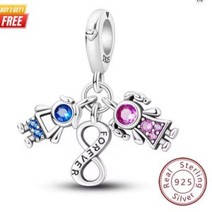 May include: A sterling silver charm featuring an infinity symbol engraved with the word FOREVER, suspended from a bail stamped with S925. Two stylised figures are attached, one with a blue stone and one with a pink stone set in the centre.