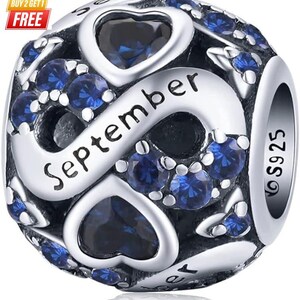 May include: A silver charm bead featuring an infinity symbol design with the word September engraved in black script. The bead is decorated with multiple round blue stones and heart-shaped blue stones, with the hallmark S925 stamped on the side.