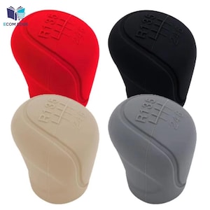 May include: Four gear shift knobs in red, black, beige, and gray. Each knob has the gear pattern R135 and 246 printed on the top. The knobs are made of a smooth, matte material.