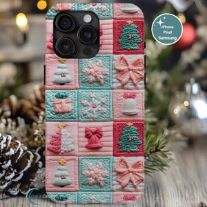 May include: A phone case with a quilted Christmas design. The case features squares with Christmas trees, snowflakes, bows, and bells in pink, teal, and white. The case is designed for iPhone, Pixel, and Samsung phones.