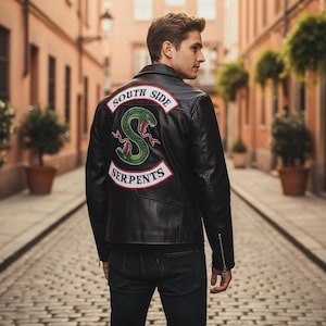 May include: Black leather jacket with a "South Side Serpents" patch on the back. The patch features a green snake design with red accents and the words "South Side" and "Serpents" in white lettering.