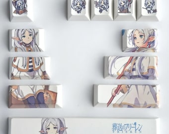 May include: A collection of white keyboard keycaps featuring anime-style illustrations. The keycaps display various images of a female character with white hair and a staff, along with Japanese text.