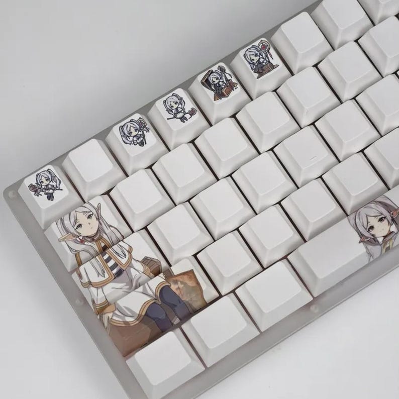 May include: White mechanical keyboard with custom keycaps featuring anime-style character illustrations. The keycaps have various designs, including full character portraits and smaller character icons. The keyboard has a clear, transparent frame.