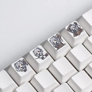 May include: White keyboard keys with anime-style character designs. The keycaps feature illustrations of a female character with white hair and various poses, including holding a staff and sitting on a chest.