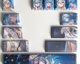 May include: A collection of custom keycaps featuring anime-style illustrations of a female character with blue hair and clothing. The keycaps are in various sizes and shapes, with detailed artwork and a glossy finish.