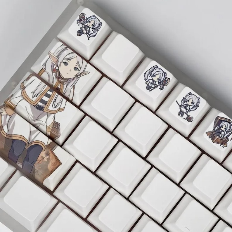 May include: White mechanical keyboard keycaps with anime-style character art. The keycaps feature illustrations of a female elf character and other small character designs. The keyboard keys are arranged in a grid pattern.