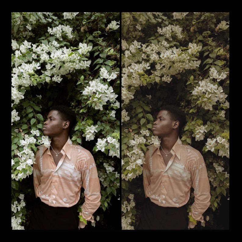 May include: A person wearing a peach-colored shirt with a white pattern stands in front of a wall of white flowers. The person is looking to the right of the frame.