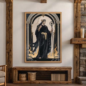 May include: Framed art print featuring a figure in black robes with a golden belt, holding a staff with a skull. The artwork has a gothic theme, set against a backdrop of an archway and flames. The frame is a light wood color.