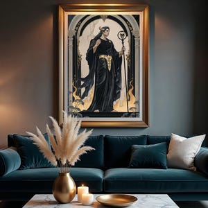 May include: A framed artwork depicting a figure in black robes holding a staff, set against an arched background. The artwork is framed in gold and hangs above a teal sofa with decorative pillows. A gold vase with pampas grass and candles are on the coffee table.