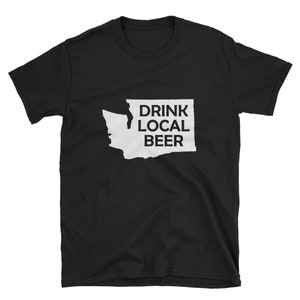 May include: Black t-shirt featuring a white outline of the state of Washington with the text "DRINK LOCAL BEER" inside the outline.