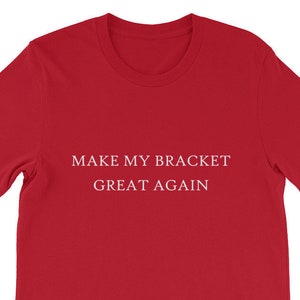 May include: Red t-shirt with white text that reads "MAKE MY BRACKET GREAT AGAIN".