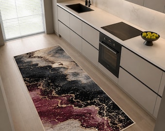May include: A rectangular area rug featuring an abstract marble-like pattern with deep burgundy, charcoal black, and soft grey tones, accented by thin, flowing gold-coloured veins that create a layered, fluid design across the entire surface.