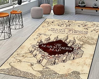 May include: Beige rectangular rug featuring a map design with the text "The Marauders Map". The map has a castle illustration in the center with the text "Moony, Wormtail, Padfoot & Prongs are proud to present".