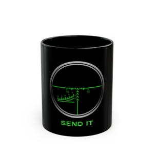 May include: Black ceramic mug with a green and white targeting reticle graphic. The text "SEND IT" is printed in green below the reticle. The mug is cylindrical and has a glossy finish.