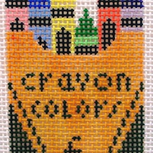 May include: A cross-stitch design of a yellow crayon box with the words "School Days" stitched in green thread. The box is filled with colorful crayons, including red, orange, yellow, green, blue, purple, and pink.