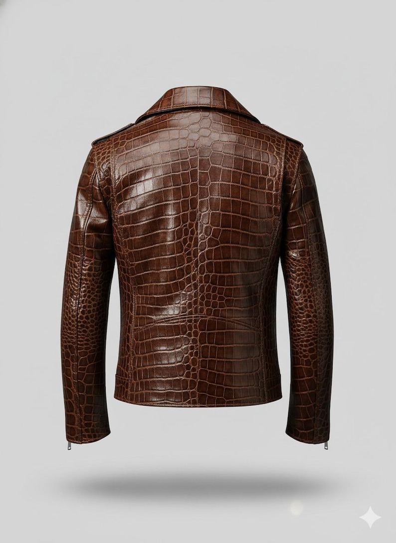 Puede incluir: Chaqueta de cuero marr&oacute;n con textura de piel de cocodrilo. La chaqueta tiene un estilo motero cl&aacute;sico con cuello de solapa, charreteras y cierre de cremallera. La vista trasera muestra el patr&oacute;n y las costuras detalladas.