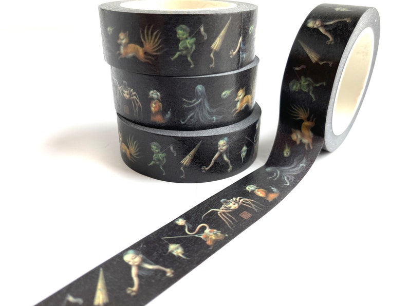 May include: Four rolls of black washi tape with colourful illustrations of fantastical creatures. The tape is unrolled to show the design.