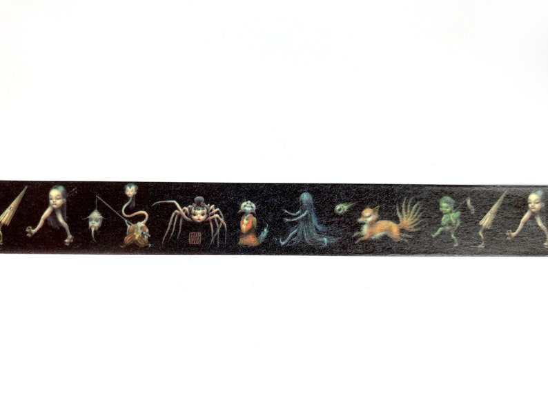May include: Black and white washi tape with a repeating pattern of various creatures, including a spider, a fox, a ghost, and a fairy. The tape is on a white background.