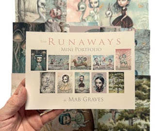 May include: A cream-colored portfolio titled The Runaways Mini Portfolio by Mab Graves, featuring a grid of ten small illustrations of stylized characters and animals, layered over a collection of larger prints with similar artistic themes.