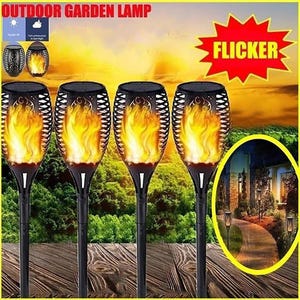 May include: Four black outdoor garden lamps with a flickering flame effect. The lamps have a decorative cage design around the flame. The image also includes the text "OUTDOOR GARDEN LAMP" and "FLICKER".