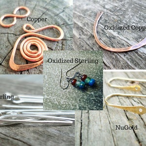 May include: Four different types of earring wires: copper, oxidized copper, sterling silver, and NuGold. The copper wires are in the shape of an infinity symbol and a spiral. The oxidized copper wire is a simple curved shape. The sterling silver wires are straight and have a loop at one end. The NuGold wires are curved and have a small hole at one end.