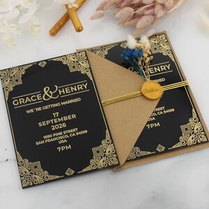May include: Black and gold wedding invitation with a gold wax seal and the text "Grace & Henry We're getting married" and the date "September 17, 2026".