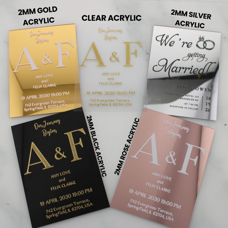 May include: Five acrylic wedding invitations with different colors and finishes. The invitations feature the text "Our Journey Begins" and the initials "A&F" in gold lettering. The invitations also include the names "Amy Love and Felix Clarke" and the date "19 April 2030 19:00 PM".