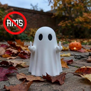 May include: A white ghost figurine with black oval eyes, featuring arms raised with middle fingers extended. The ghost has a smooth, matte finish and a draped, sheet-like appearance. A red circle with a diagonal line crosses out the text AMS.
