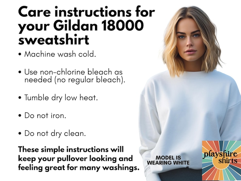 May include: White Gildan 18000 sweatshirt with care instructions. The text includes washing instructions: machine wash cold, use non-chlorine bleach, tumble dry low heat, do not iron, and do not dry clean. The model is wearing white.