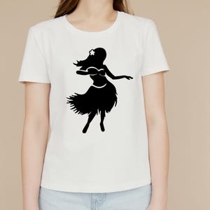 May include: White t-shirt with a black silhouette of a hula dancer wearing a flower in her hair.