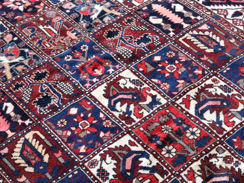 The image is a close-up of a vibrant, intricately patterned rug with a variety of colors and designs.