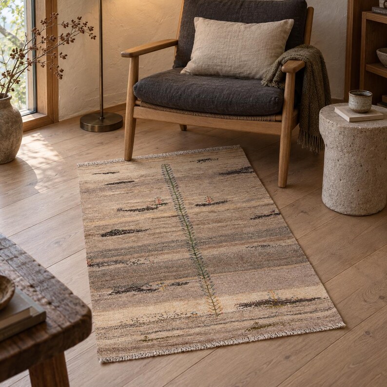 AI-generated room visualization showing a beige striped accent rug beside a wood-framed armchair. Refer to the product photos for rug details.